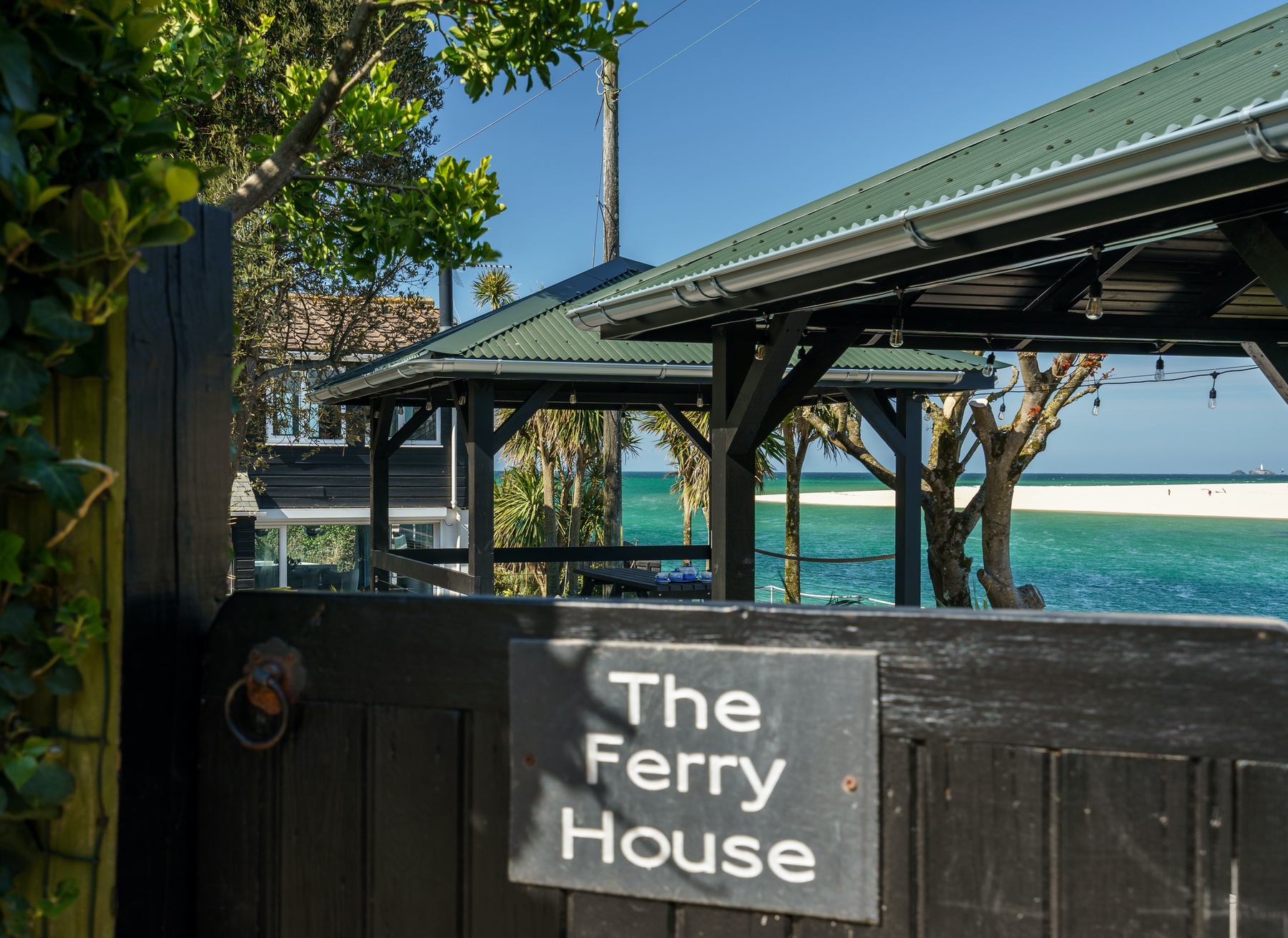 Ferry House Garden Gate Sign with Sea in distance