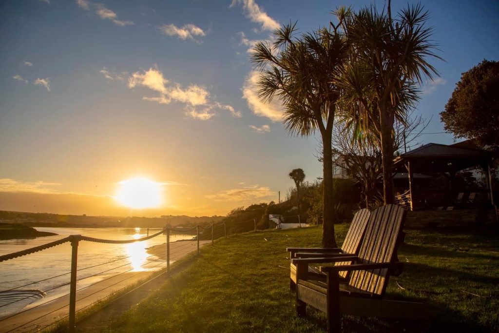 Two Adirondack Chairs facing the ocean at Sunrise