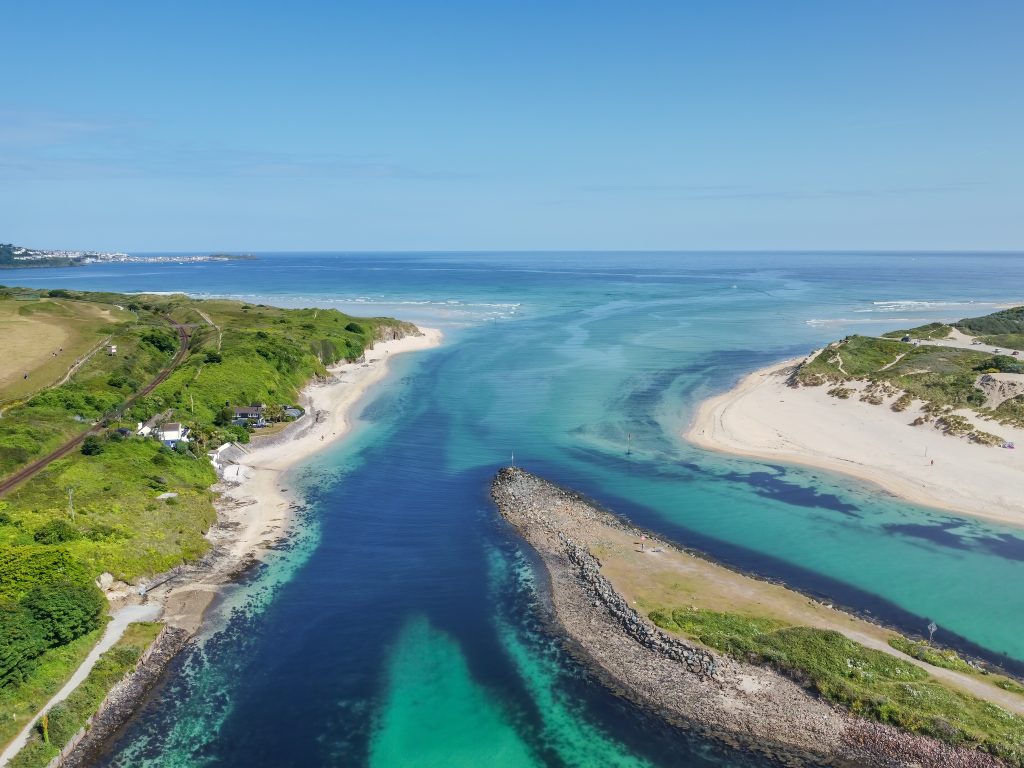 Aerial Image of the Beach Pads on the azure blue St. Ives Bay Seawith St. Ives in the distance